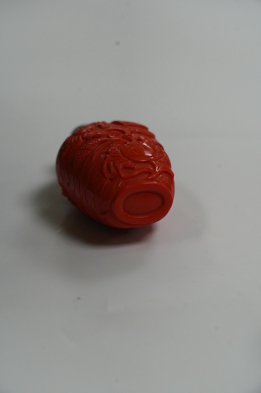 A Chinese coral coloured glass 'crabs' snuff bottle, 8.2cm high. Condition - good